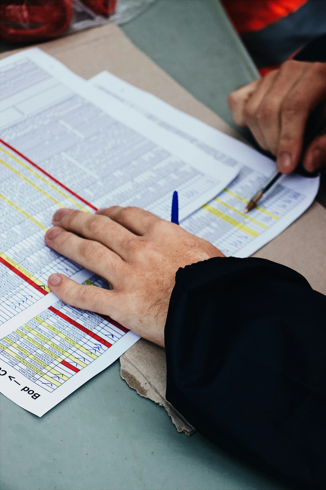 about-04 persons-hand-on-two-stack-of-paper-a7bbjzmdqk4