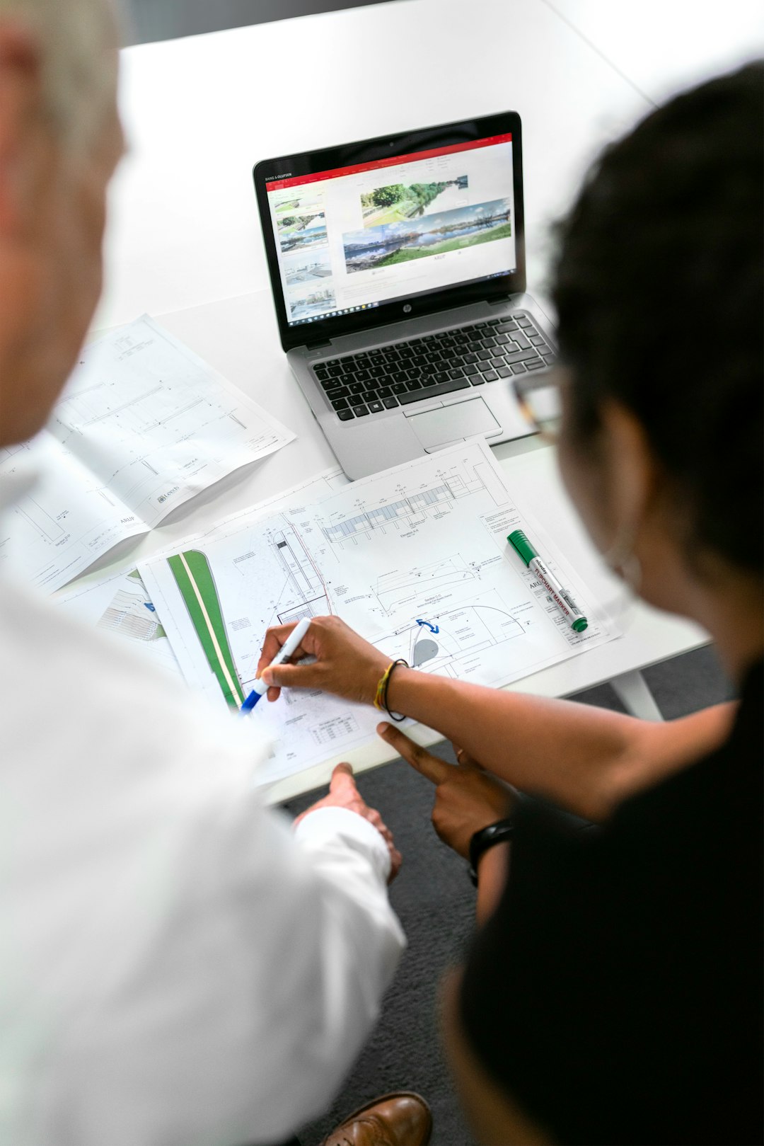 about-01 Female civil engineer discusses flood risk management plans with colleague